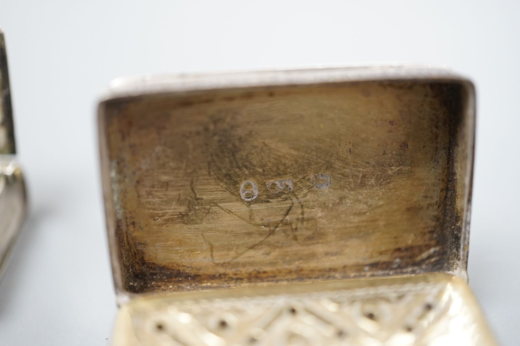 A George IV novelty silver vinaigrette, modelled as a handbag, Gervase Wheeler, Birmingham, 1832, 27mm(handle at one end detached), one other silver vinaigrette, Edward Smith, Birmingham, 1829 and a similar silver 'book'